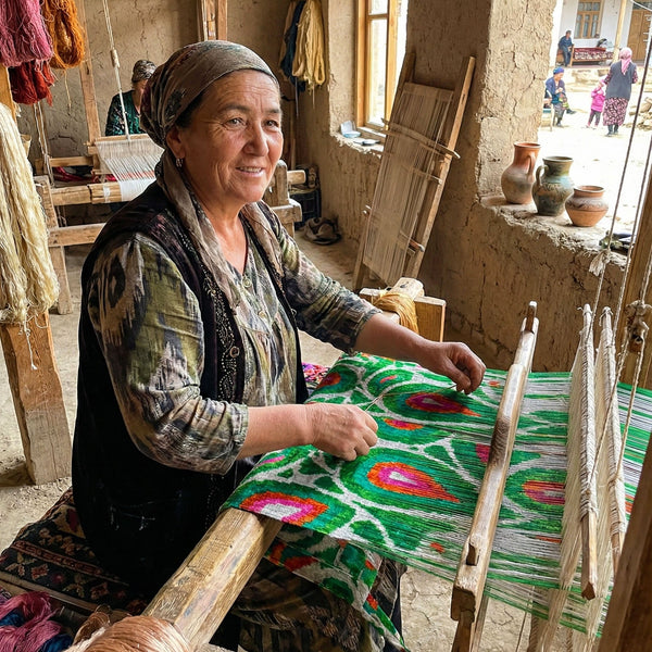 Woman weaving on a traditional loom in a rustic setting